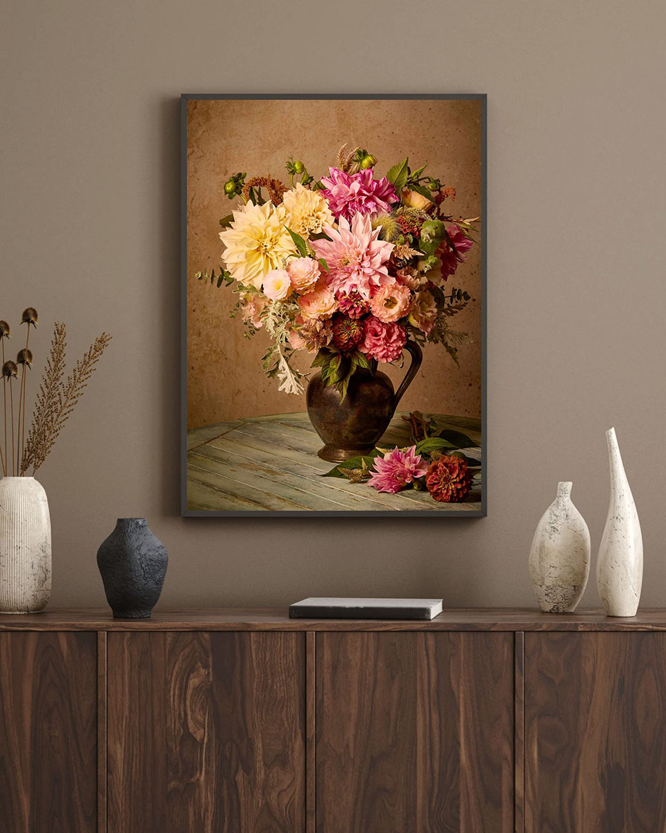 Image of the same dahlia floral bouquet with a black frame on a medium gray wall in an office