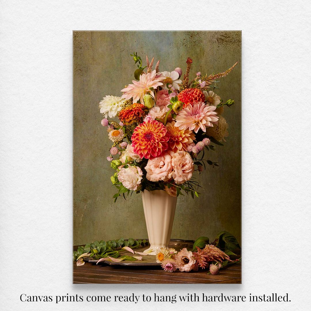 The Victorian Bouquet is a canvas wall art print showcasing a tall vase with vibrant pink, orange, and white flowers against a muted green background. The prints are ready to hang with hardware installed.