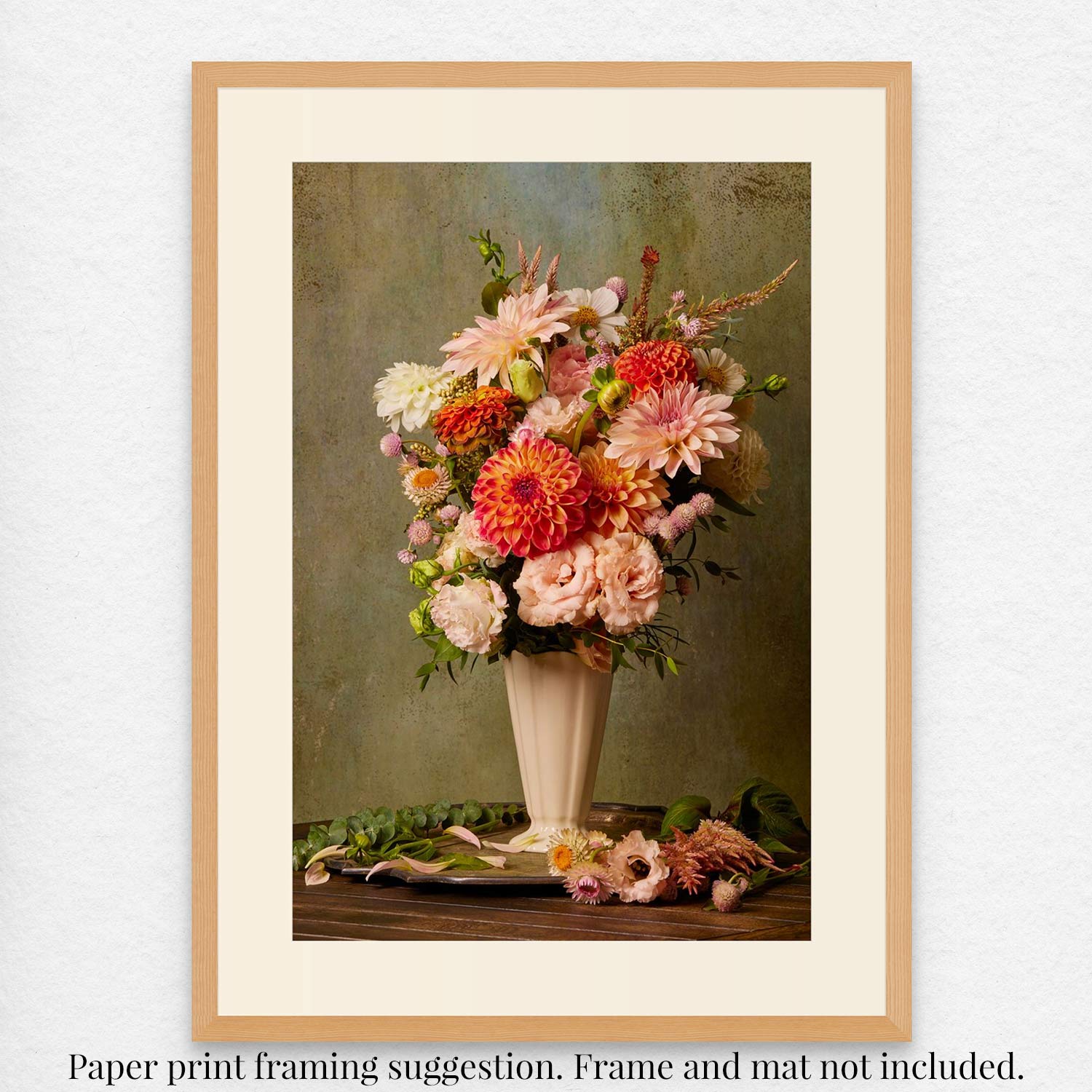 The Victorian Bouquet framed print features a vivid floral arrangement in a vase, reflecting Victorian floriography. With pink, orange, and white blossoms on a textured green backdrop and artistically placed flowers on the table.