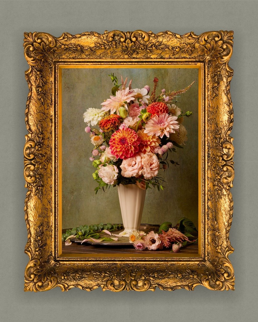 The Victorian Bouquet framed canvas wall art depicting a bouquet in shades of pink, orange, and white set against a muted green backdrop. An ornate gold frame adds classic elegance to this stunning example of floriography.