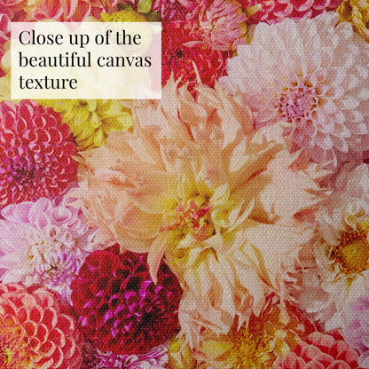 A close-up image of the Dahlia Bed - Blooming Radiance canvas showcases a vibrant floral pattern. It features pink, white, yellow, and red dahlias with intricate petal details in a vivid tapestry. Text reads Close up of the beautiful canvas texture.