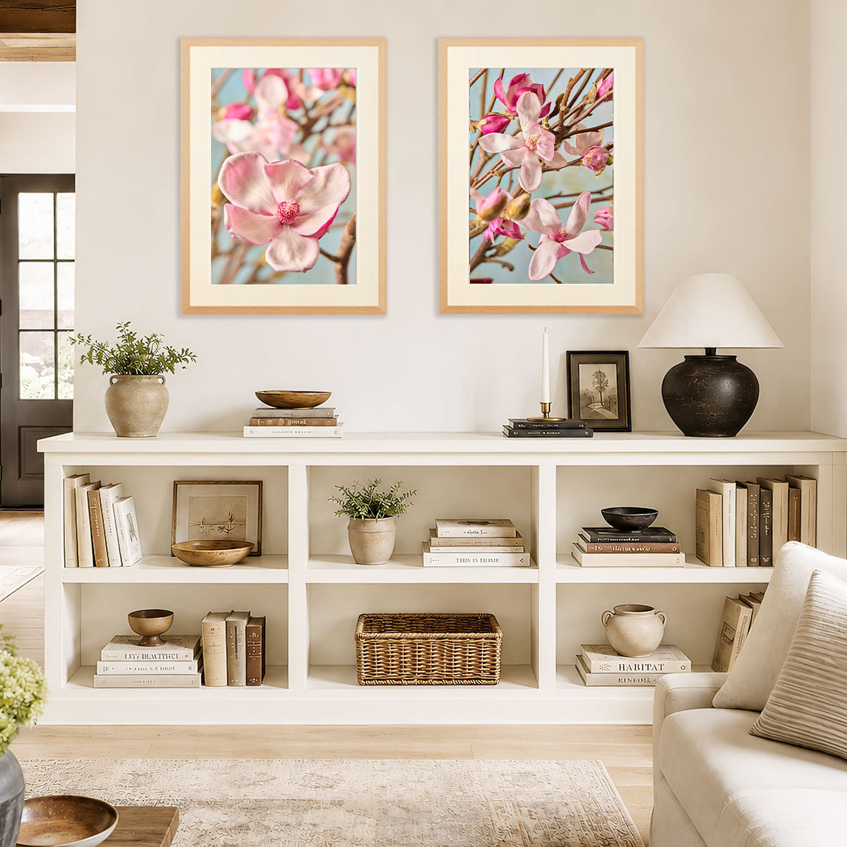 Magnolia Duo Wall Art Print Set gold wall art with two framed pink magnolia flower portraits on a living room wall