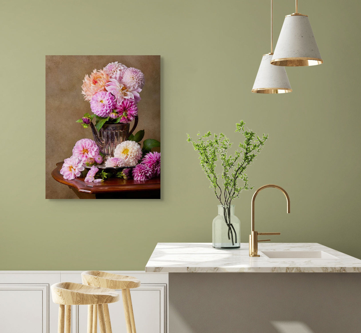 A modern kitchen with a marble countertop, a vase holding green branches and two wooden stools nearby. The Dahlia Tea Party canvas wall art hangs on a sage colored wall.