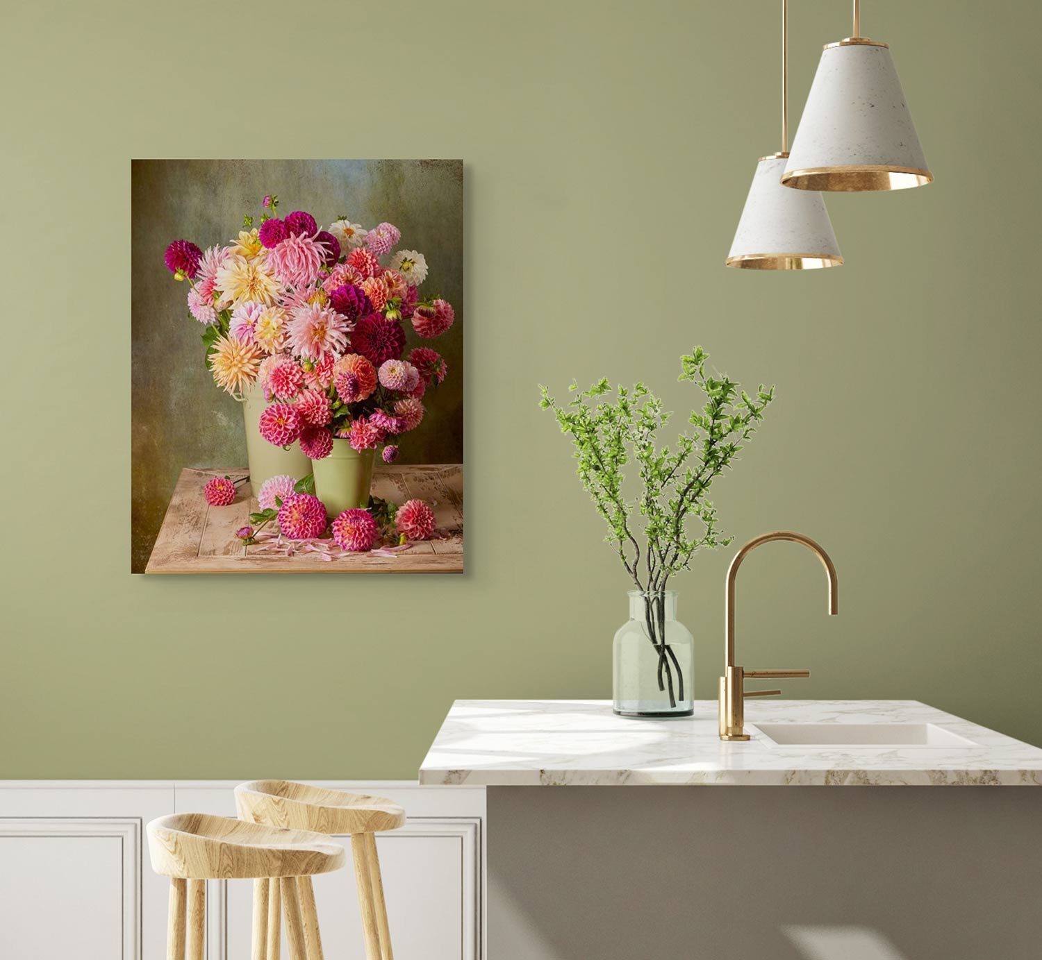 A kitchen features a light green wall with The Dahlia Harvest vibrant floral canvas wall art, a light marble countertop with a gold faucet, and a vase with green branches. Two white pendant lights hang above wooden stools.