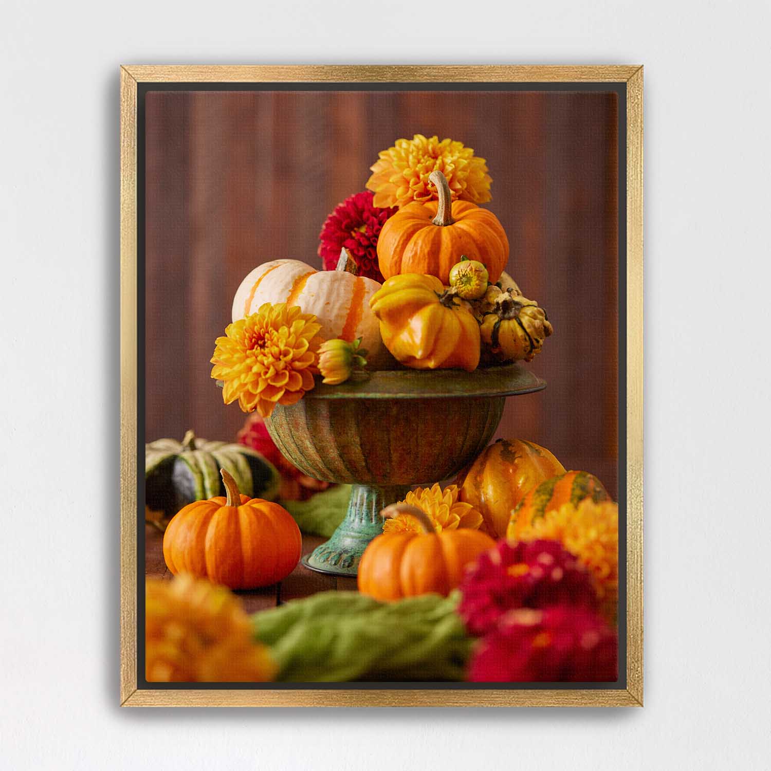 Gold Framed canvas of pumpkins and dahlias on a wooden surface with a brown background