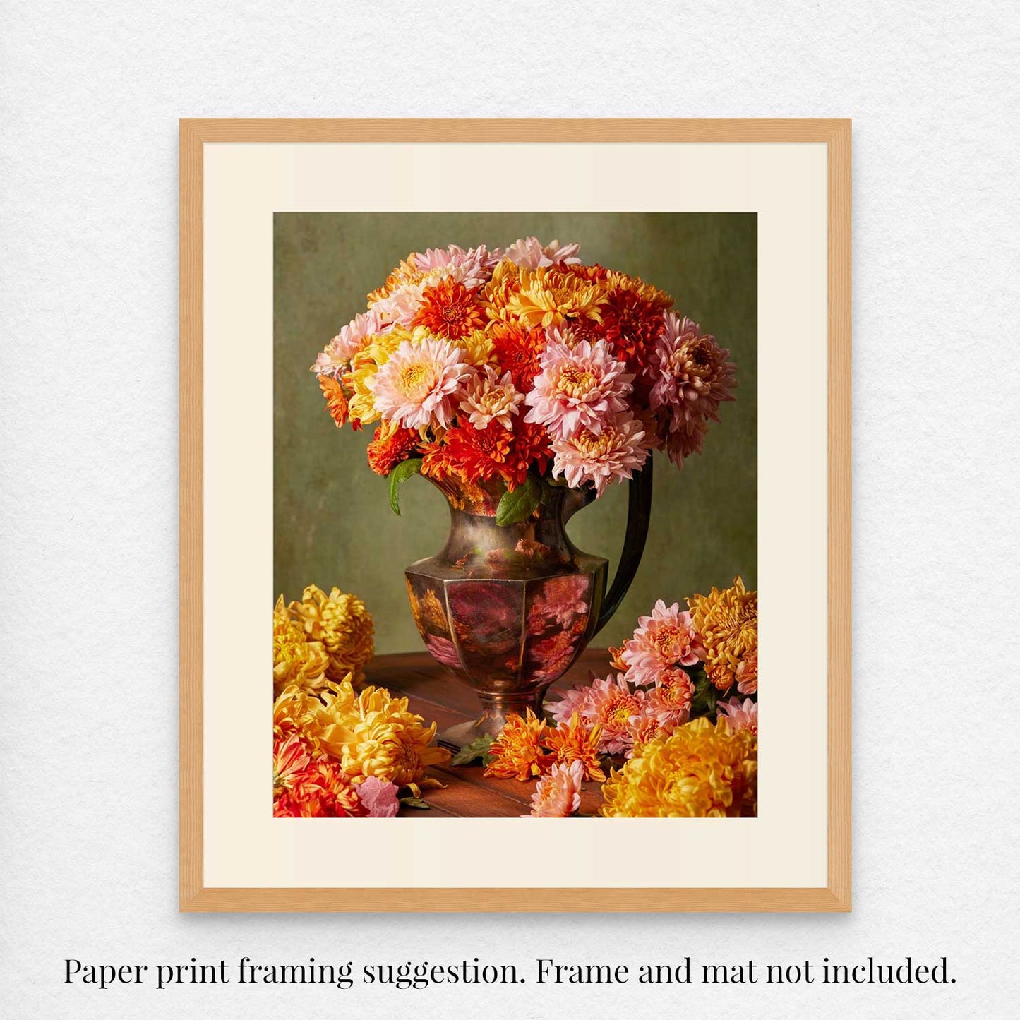 Harvested Harmony features a vintage antique silver vase filled with pink, orange, and yellow autumn flowers, with extra blooms scattered on the table. The text clarifies that framing is suggested and does not include frame or mat.