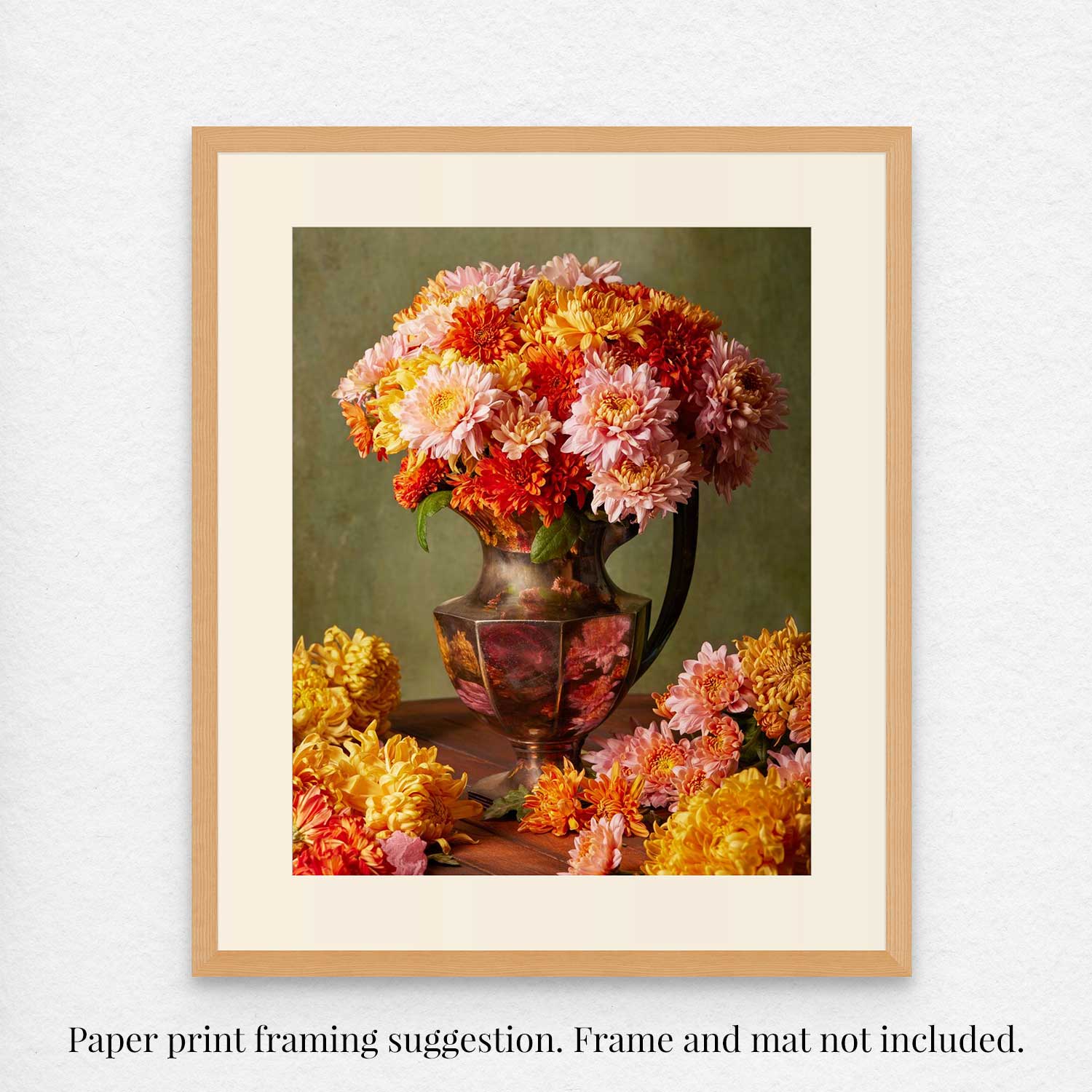 Harvested Harmony features a vintage antique silver vase filled with pink, orange, and yellow autumn flowers, with extra blooms scattered on the table. The text clarifies that framing is suggested and does not include frame or mat.