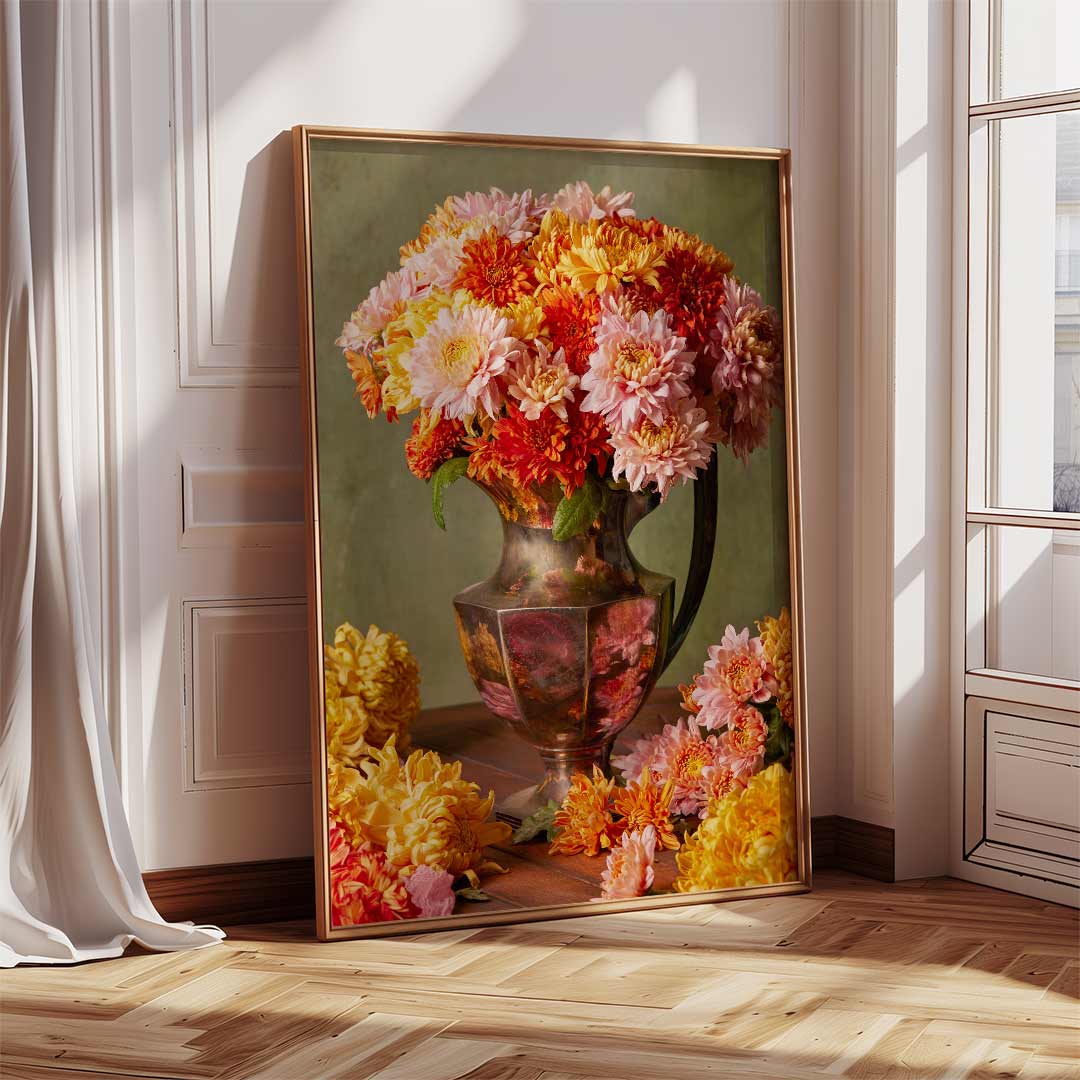 The Harvested Harmony art canvas features vibrant autumn chrysanthemums in pink, orange, and yellow arranged in a vase. Its framed against a white wall on a wooden floor, illuminated by soft natural light from a nearby window.