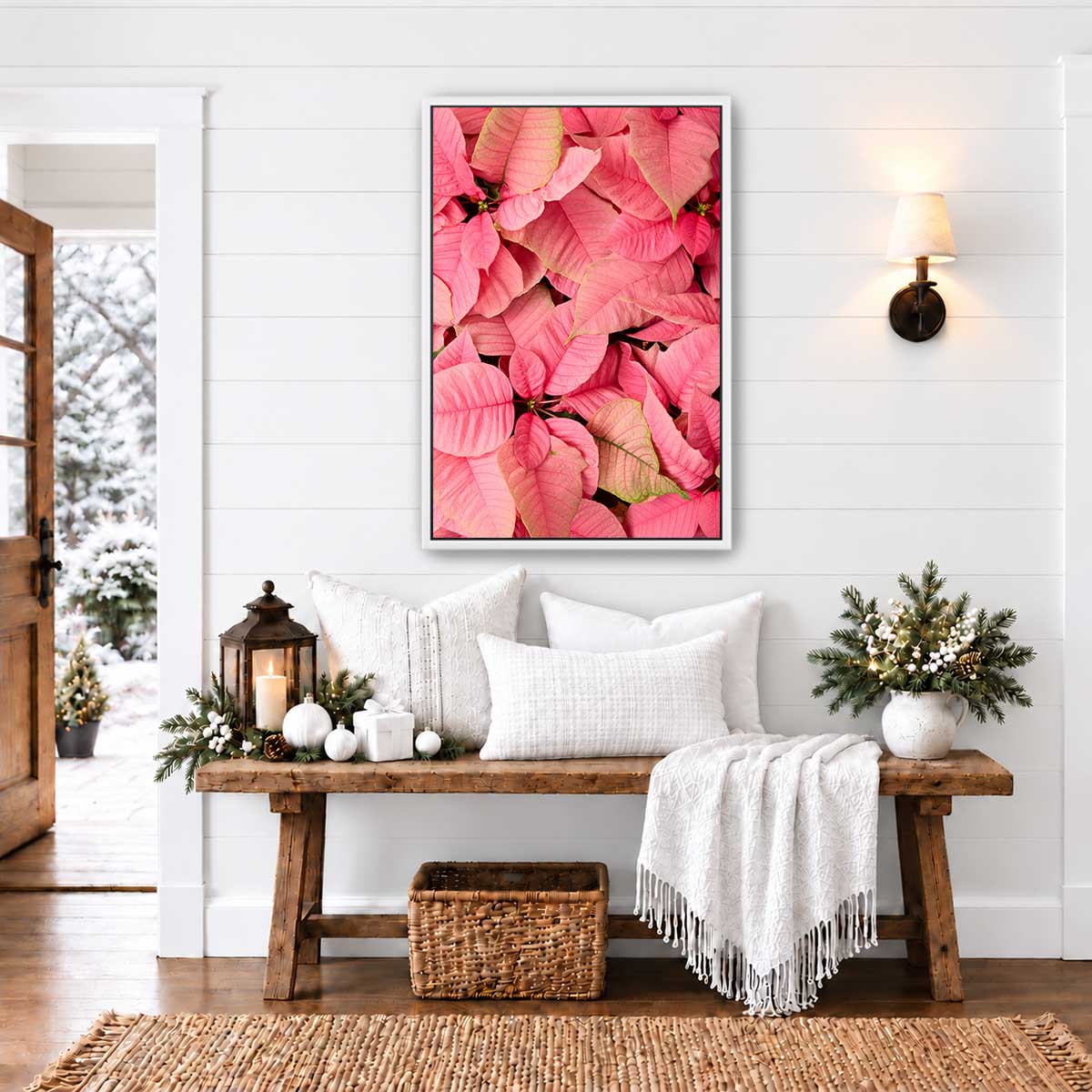 December Blush poinsettia floral wall art in pink tones shows an overhead composition of layered petals above a rustic bench.