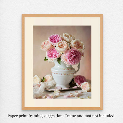 The Romance in Bloom fine art print framed showcases pink and white David Austin roses in a white vase with a soft, neutral background and scattered petals for elegance. Frame and mat are not included.