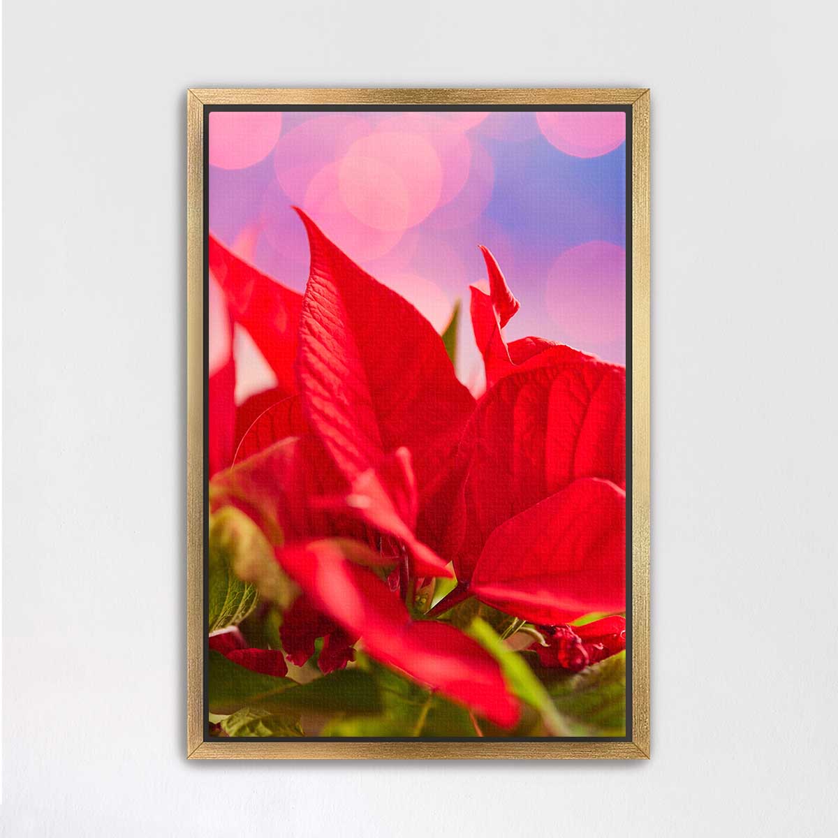 The Red Moment floral wall art in red with poinsettia leaves and soft circular light effects in a gold frame