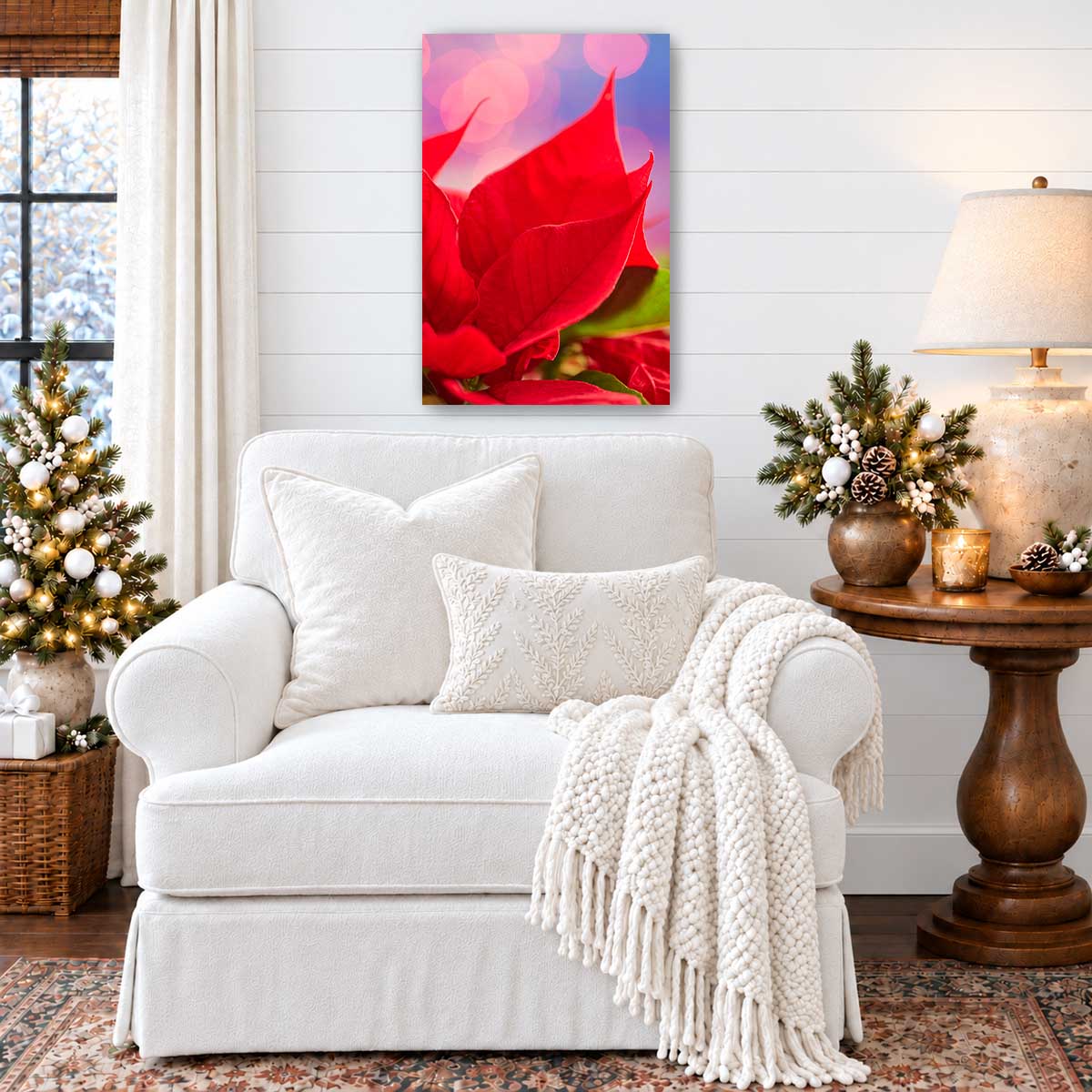 Poinsettia wall art canvas featuring vivid red petals in a vertical display above a white armchair