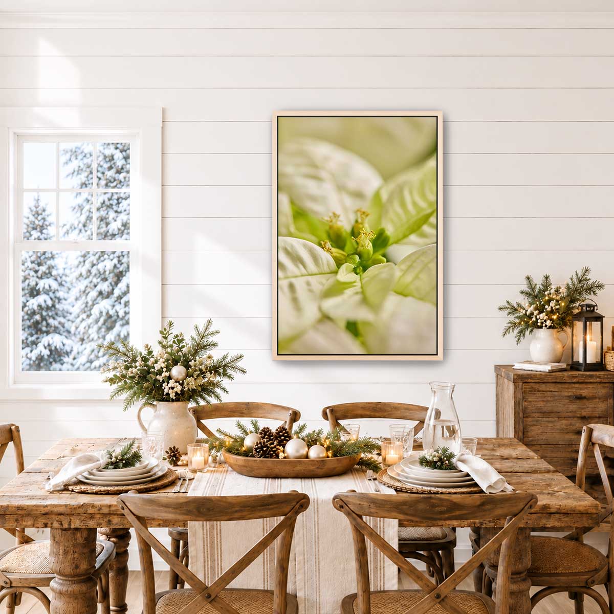 Christmas poinsettia wall art print with softly blurred bracts in a gold frame, displayed above a rustic dining table.