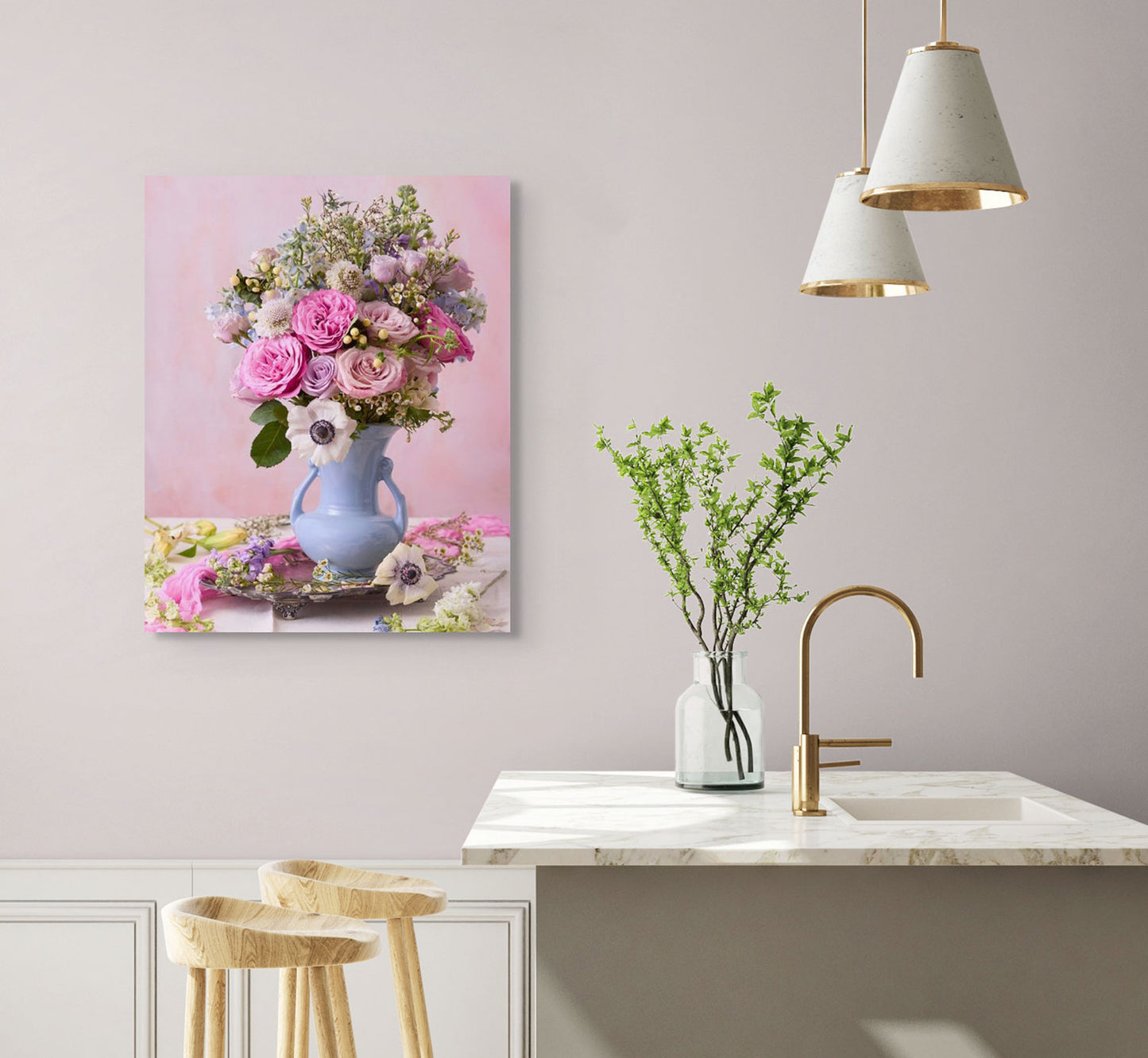 A modern kitchen with a marble countertop, wooden stools, sleek faucet, Pink and Blue Serenade canvas wall art featuring pastel roses in a blue vase, two pendant lights, and a small greenery-filled vase creates a serene space exuding modern sophistication.