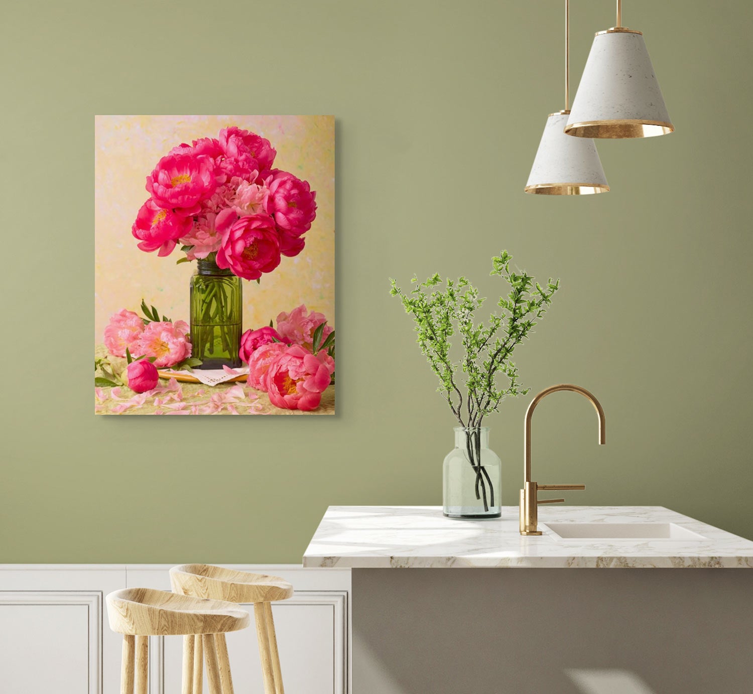 A modern kitchen features a marble countertop, gold faucet, and two wooden stools. A green vase with leafy branches on the counter. Love Story Blooming canvas art in pink floral hues adorns the olive green wall near two white pendant lights.