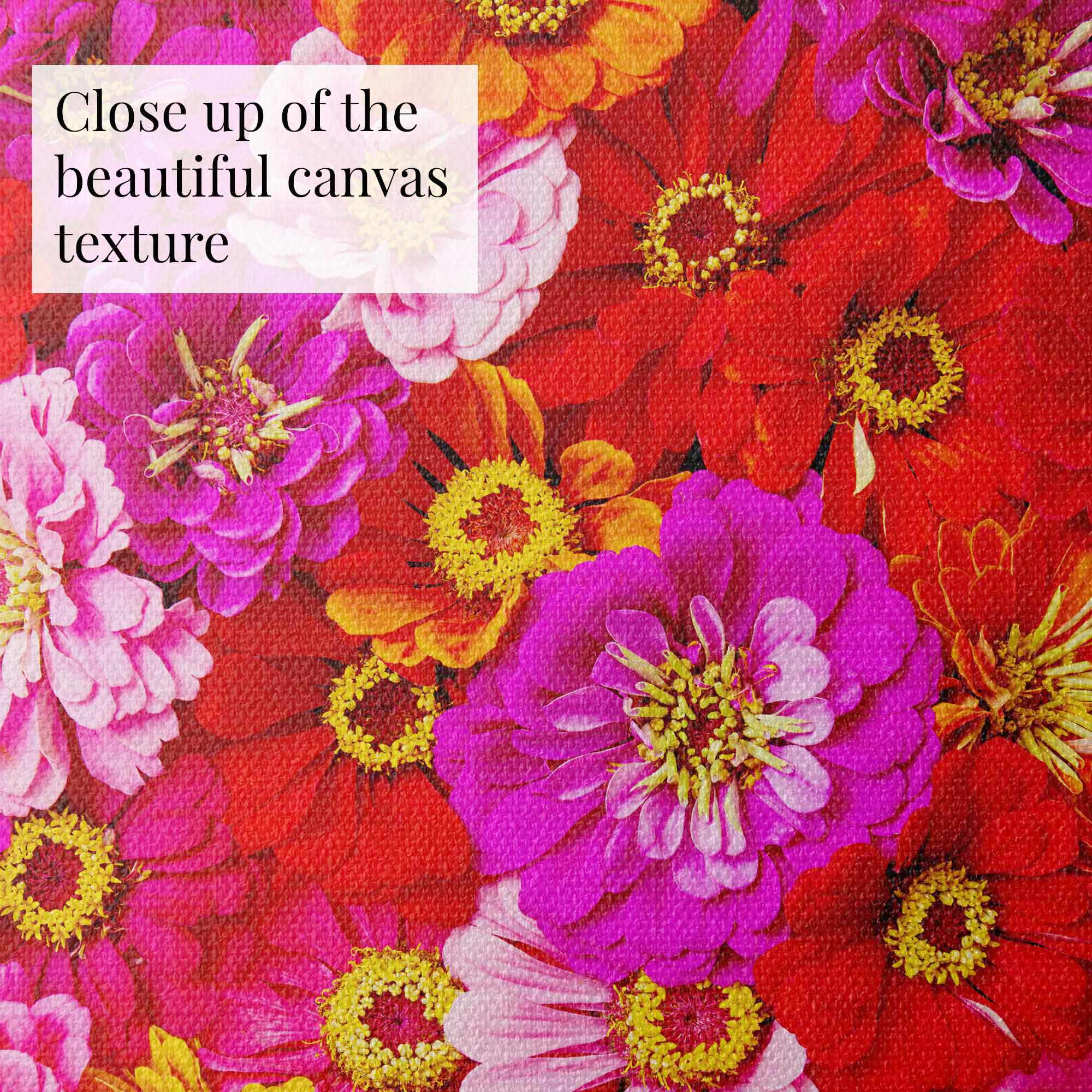 A close-up of the Zinnia Bed - Electric Radiance canvas showcases a vibrant floral pattern with zinnias in red, pink, and purple. The yellow centers add charm, while visible canvas texture enhances depth and beautifully highlights the radiant colors of this fine art canvas print.