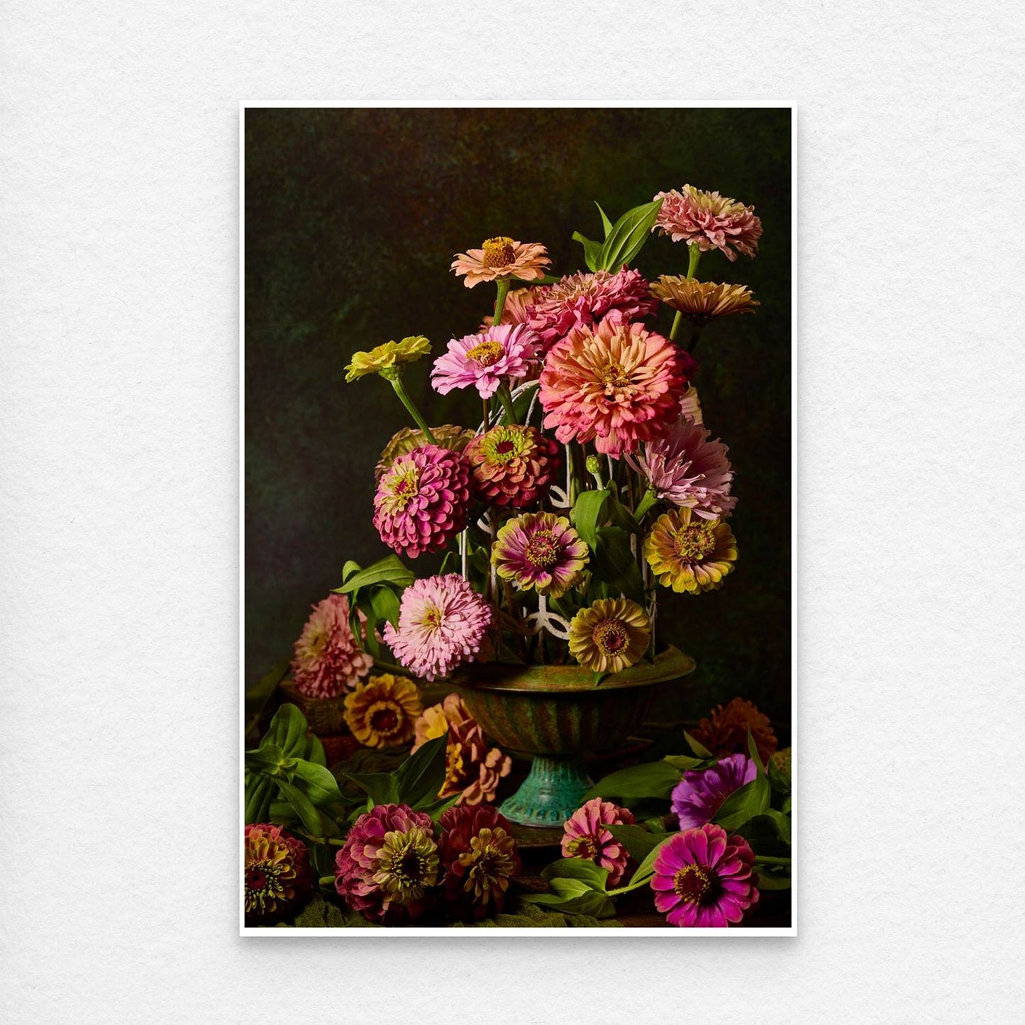 Petals In Flight is a canvas wall art showcasing vibrant pink and orange zinnias in a green vase against a dark, textured background, with cascading blooms adding depth and capturing natures lively essence with artistic flair.