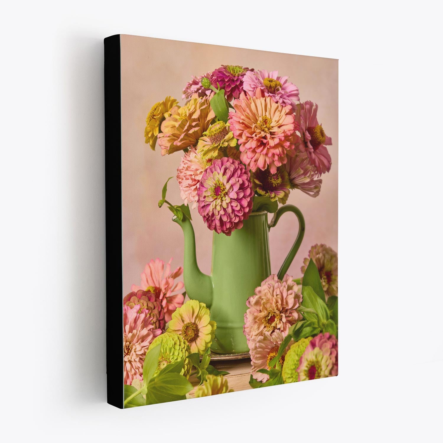 Steeping Beauty is a canvas wall art piece featuring a vintage green teapot filled with pink and yellow flowers against a peachy background, with additional blooms scattered at the base to enhance its vibrant composition.