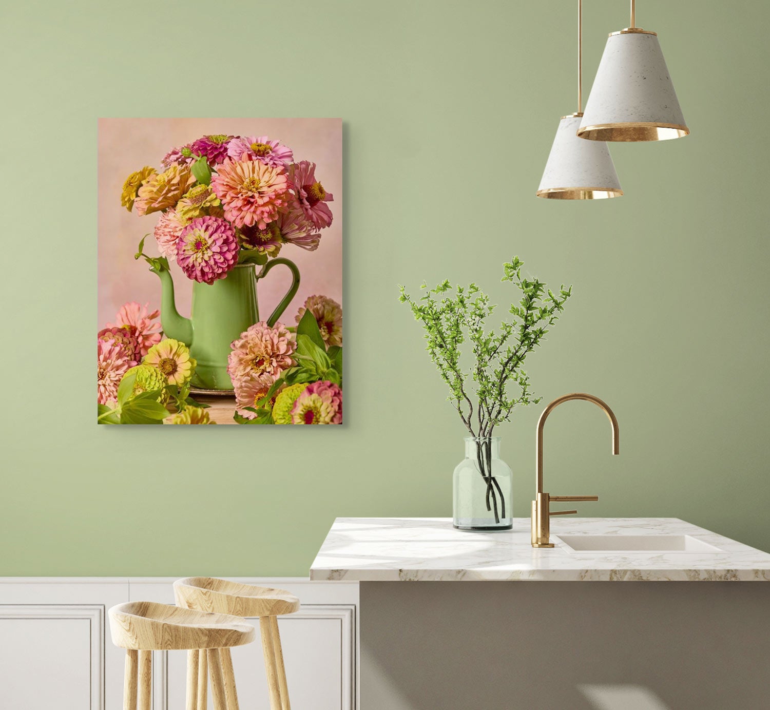 The kitchen boasts a white marble countertop with wooden stools. A green vase with branches sits next to the Steeping Beauty vintage teapot on the counter. Floral canvas wall art decorates the light green wall, illuminated by two white pendant lights above.