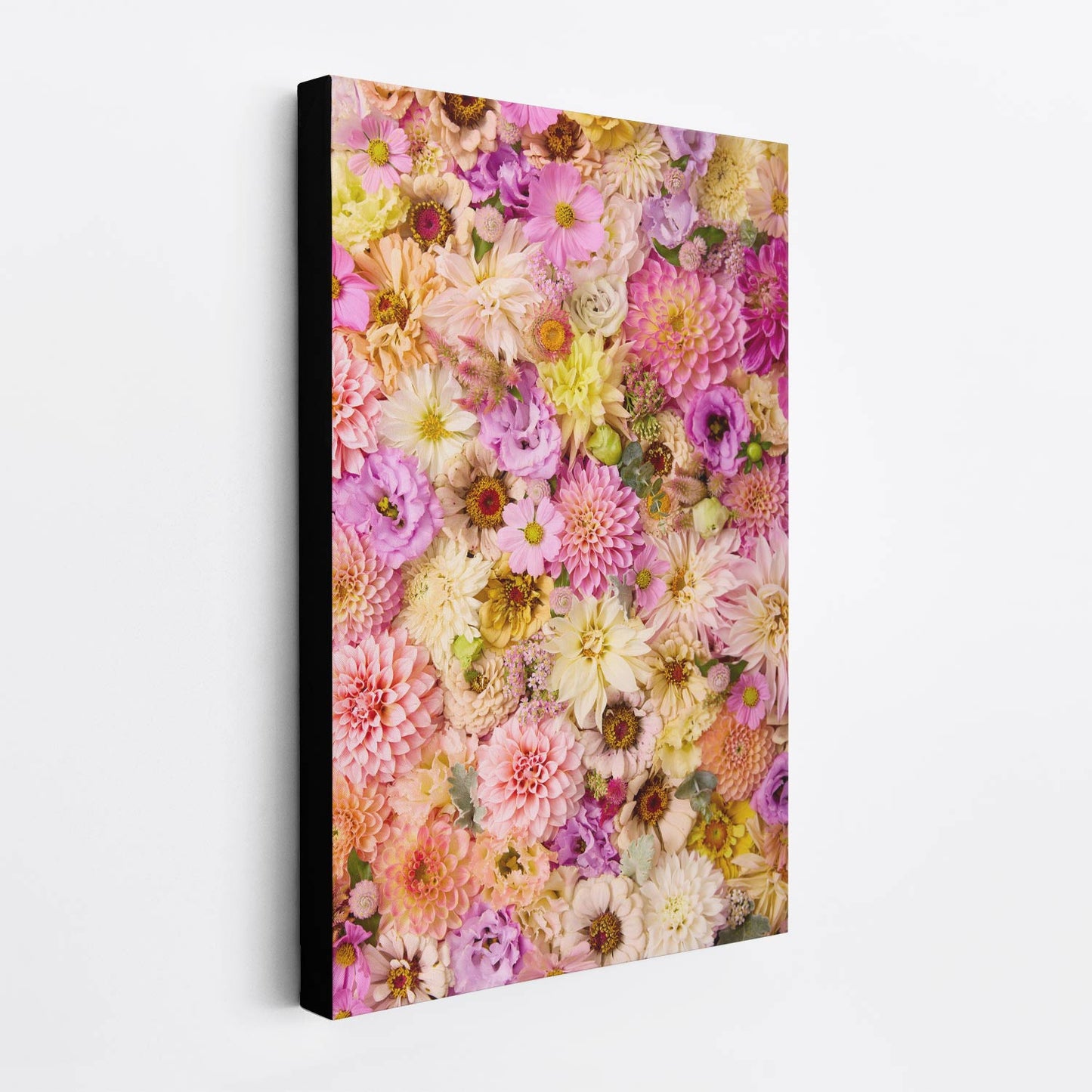 Christinas Wedding canvas print showcases vibrant, dense flower bed arrangements with multicolored blooms in pink, yellow, and purple on a white wall showing the side view of the canvas with a black edge making it appear as if its floating off the wall.