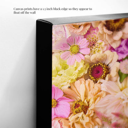 A close-up of a canvas called Christinas Wedding showcases a vibrant floral design with pink and peach flowers. The image highlights the 1.5-inch black edge, giving it a floating appearance from the wall.