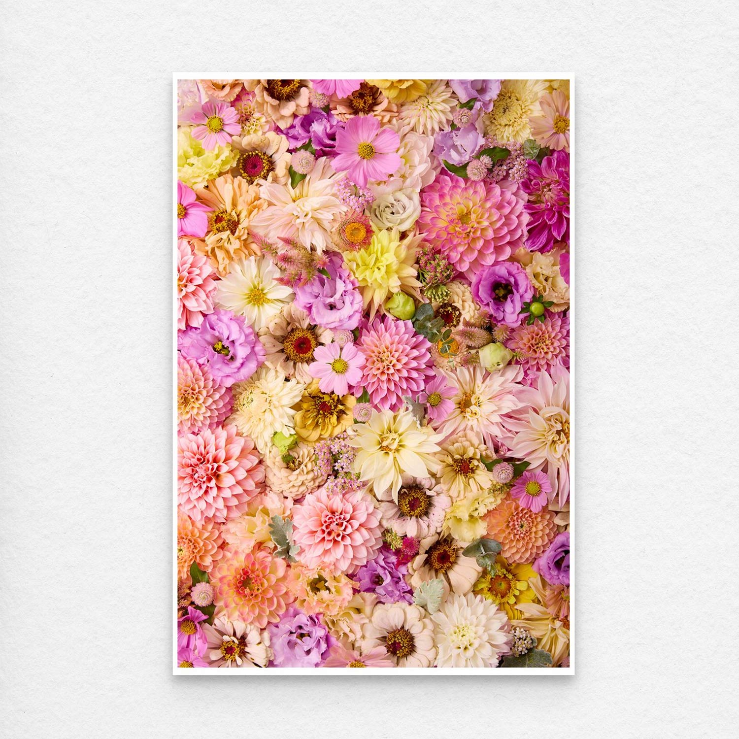 A paper print of  Christinas Wedding features a vibrant collage of pink, purple, yellow, and peach flowers arranged closely together. The print is showing a think white border, which comes with all prints for easy framing.