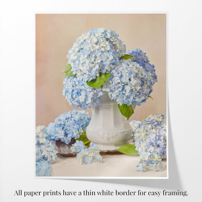 A paper print of Dreaming of Something Blue with a curled edge. The print has a white border with text below stating that all prints have a thin white border for easy framing.