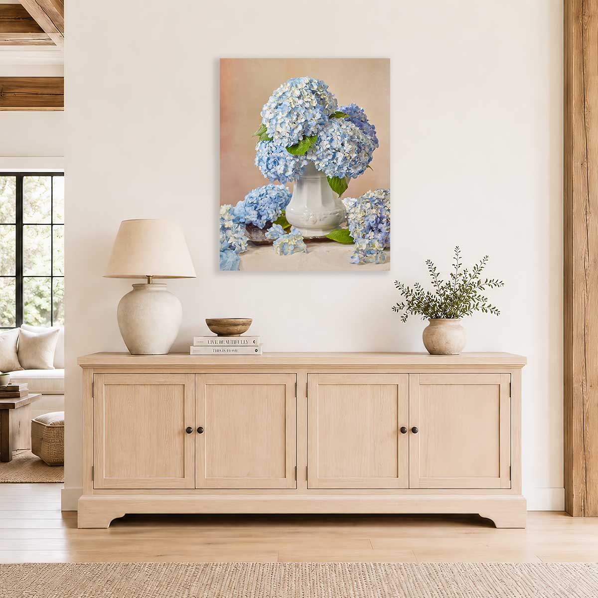 Dreaming of Something Blue Hydrangea Wall Art Canvas with blue hydrangeas and a white pitcher on a beige wall