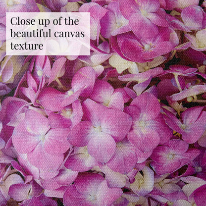 Detailing delicate hydrangea petals with a soft, woven canvas texture, this fine art canvas named Hydrangea Bed - Purple Radiance features text in the top left corner stating, “Close up of the beautiful canvas texture.”.