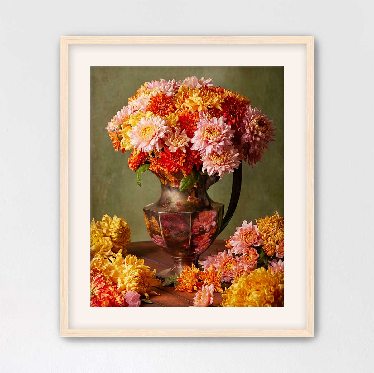 A framed image of a vase filled with a vibrant bouquet of colorful flowers, including pink, orange, and yellow blooms, set against a green background.
