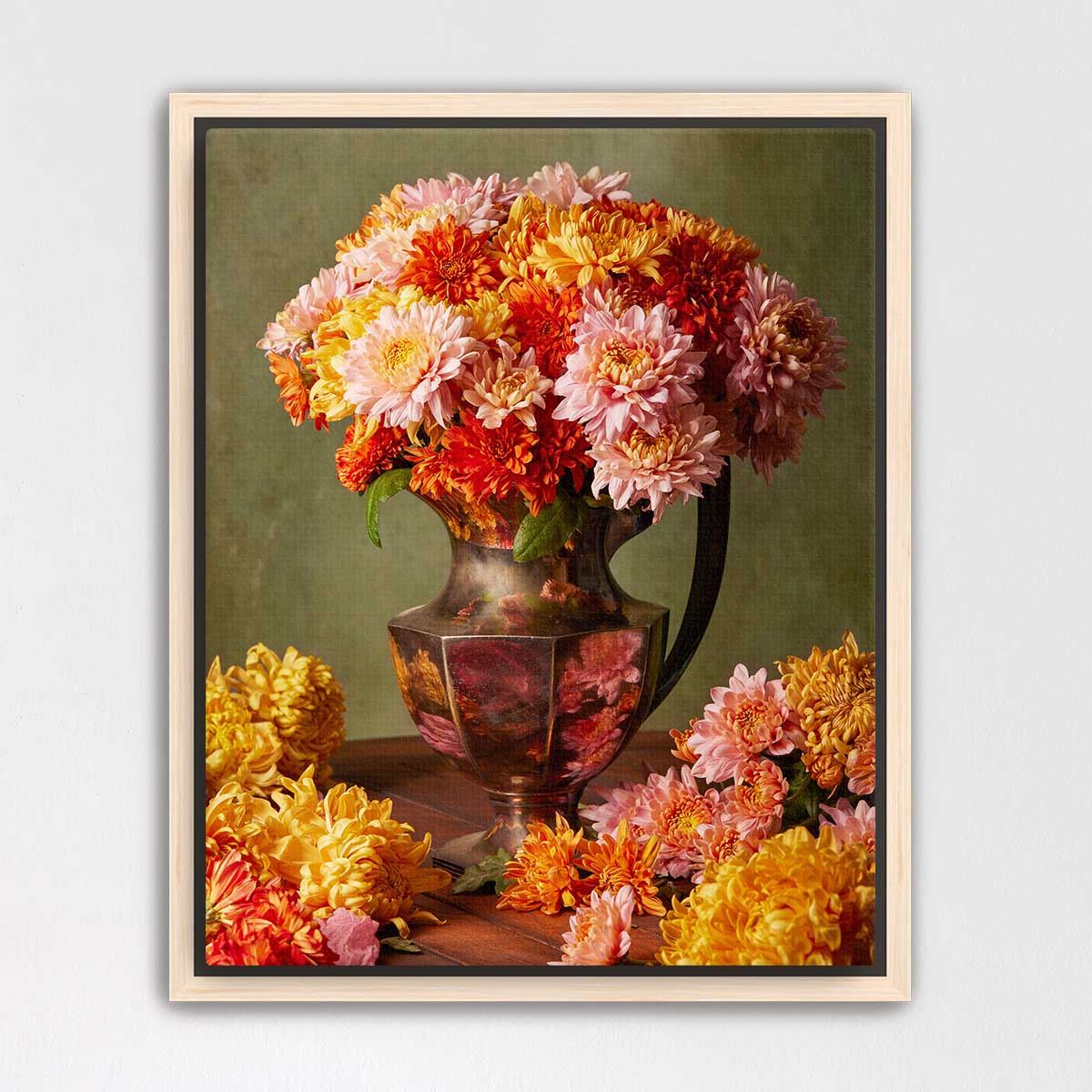 A large vase filled with a vibrant bouquet of colorful flowers, including pink, orange, and yellow blooms, sits on a wooden surface.