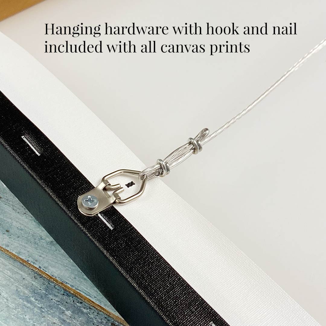 Close-up of a canvas prints back reveals a wire attached to a hook with screws. Text above states, Hanging hardware and nail included with all canvas art. Enhance your space like Steeping Beauty, a vintage green teapot, adds charm to afternoon tea.