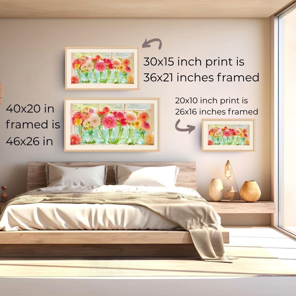 A bedroom scene showing three framed floral art prints mounted on a beige wall above a wooden bed. Text overlays explain the dimensions of each print when framed: 30x15 inch print is 36x21 inches framed, 40x20 inch print is 46x26 inches framed, and 20x10 inch print is 26x16 inches framed.