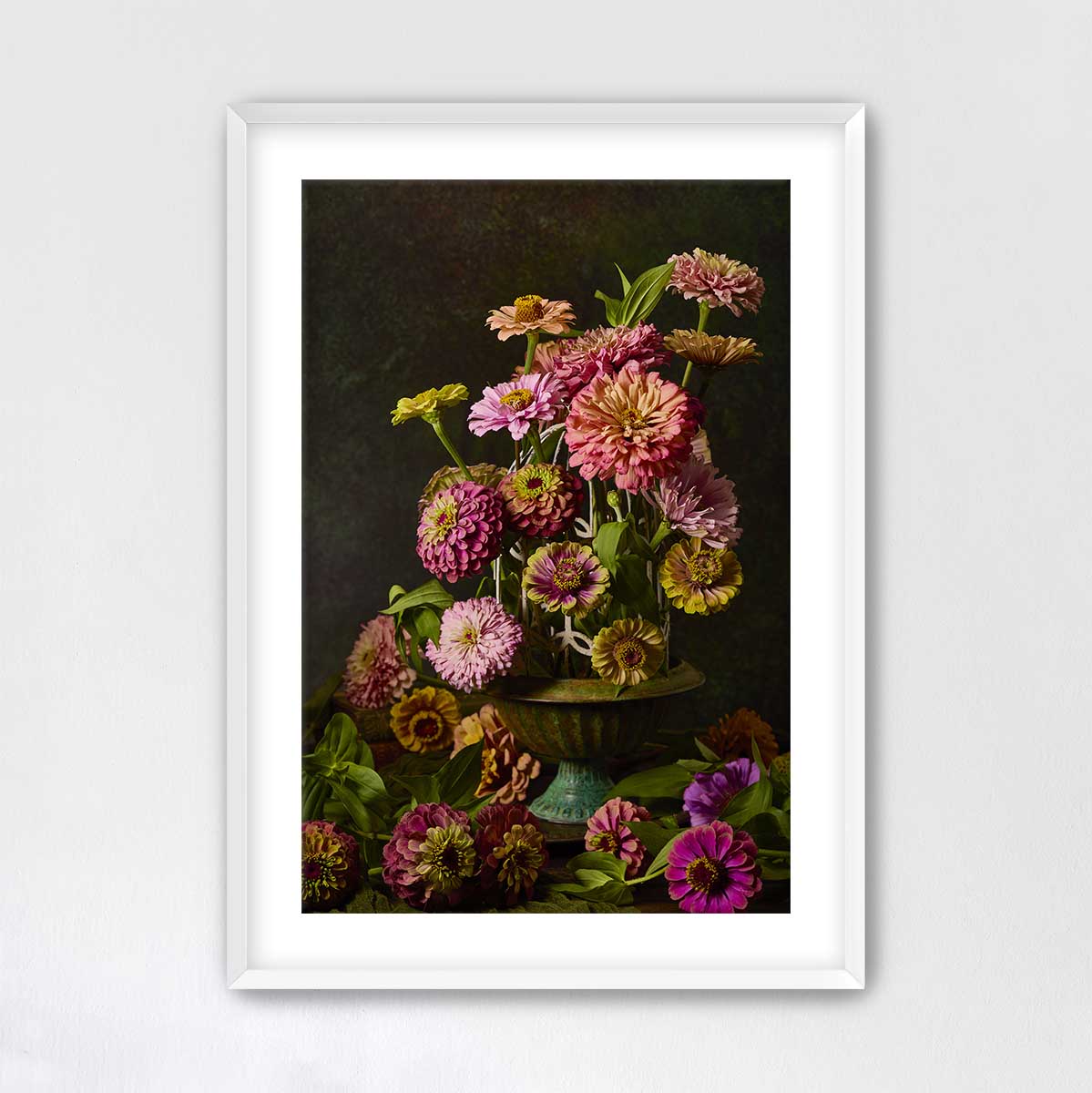 A framed image of a vase filled with a variety of colorful flowers, including pink, yellow, and purple blooms, set against a dark background.