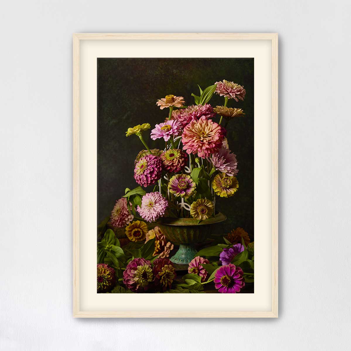A framed painting depicting a vase filled with a variety of colorful flowers, including pink, yellow, and purple blooms, set against a dark background.