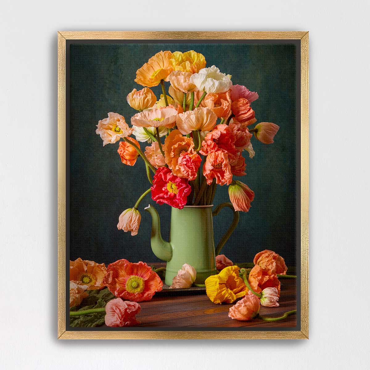 A framed still life painting depicting a vase filled with vibrant orange and pink flowers, surrounded by additional flowers on a wooden surface.