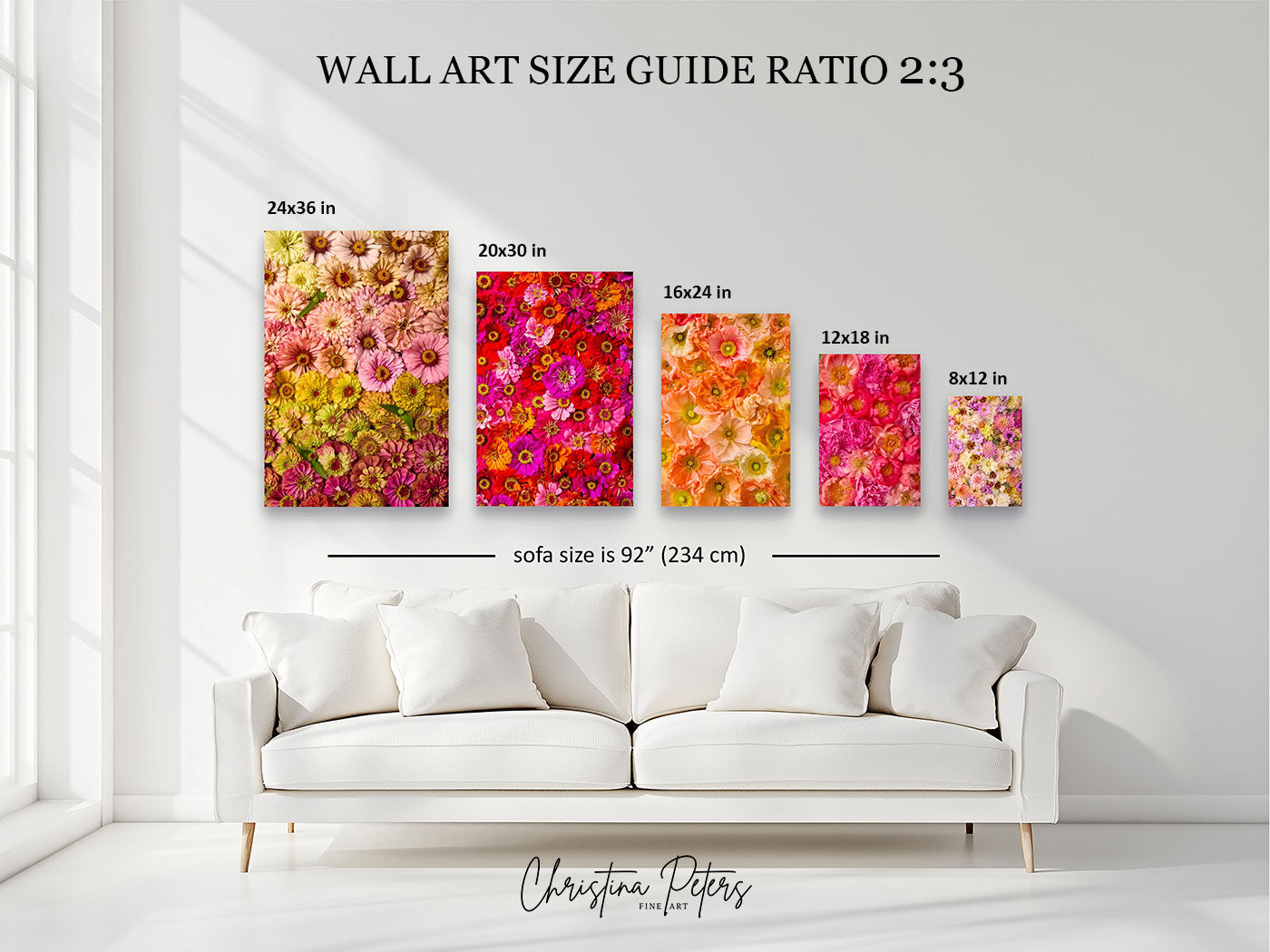 A wall art size guide mockup showing five floral canvas prints in different sizes mounted above a white sofa in a bright living room. Text at the top reads 'WALL ART SIZE GUIDE RATIO 2:3 with dimensions for each print and a sofa size reference below.