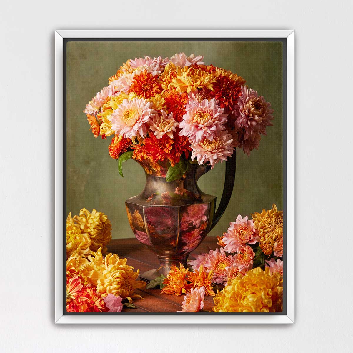 A large vase filled with a vibrant bouquet of colorful flowers, including pink, orange, and yellow blooms, sits on a wooden surface.