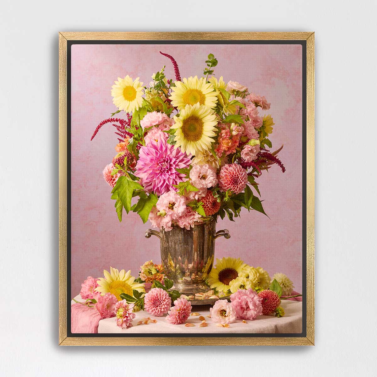 A framed image of a bouquet of colorful flowers, including sunflowers, dahlias, and other blooms, arranged in a vase.