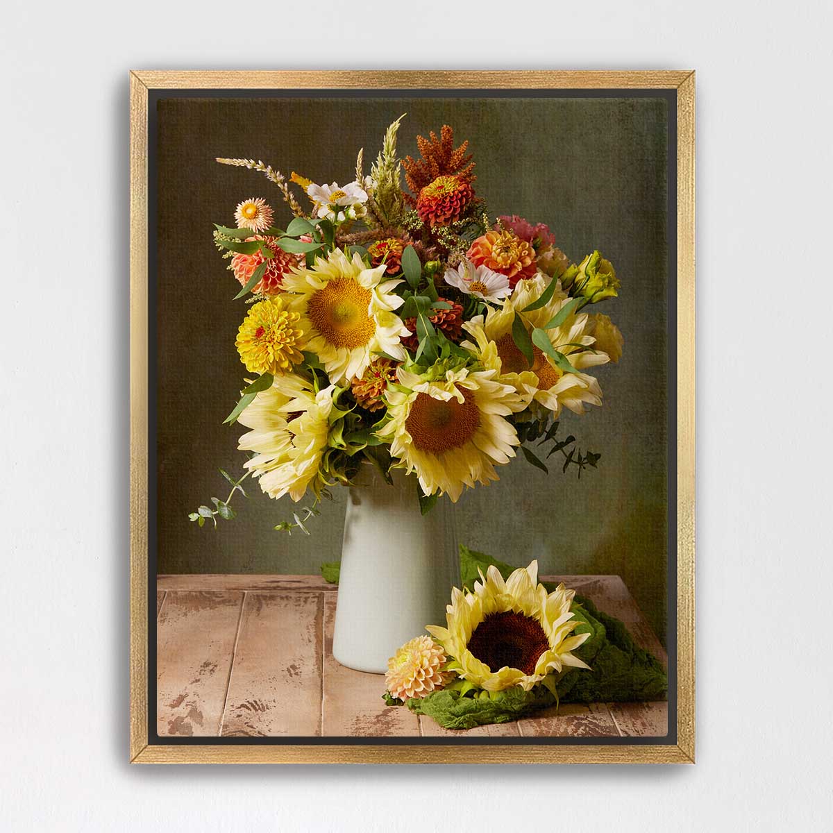 A framed still life painting depicting a bouquet of vibrant yellow sunflowers in a white vase, placed on a wooden surface.